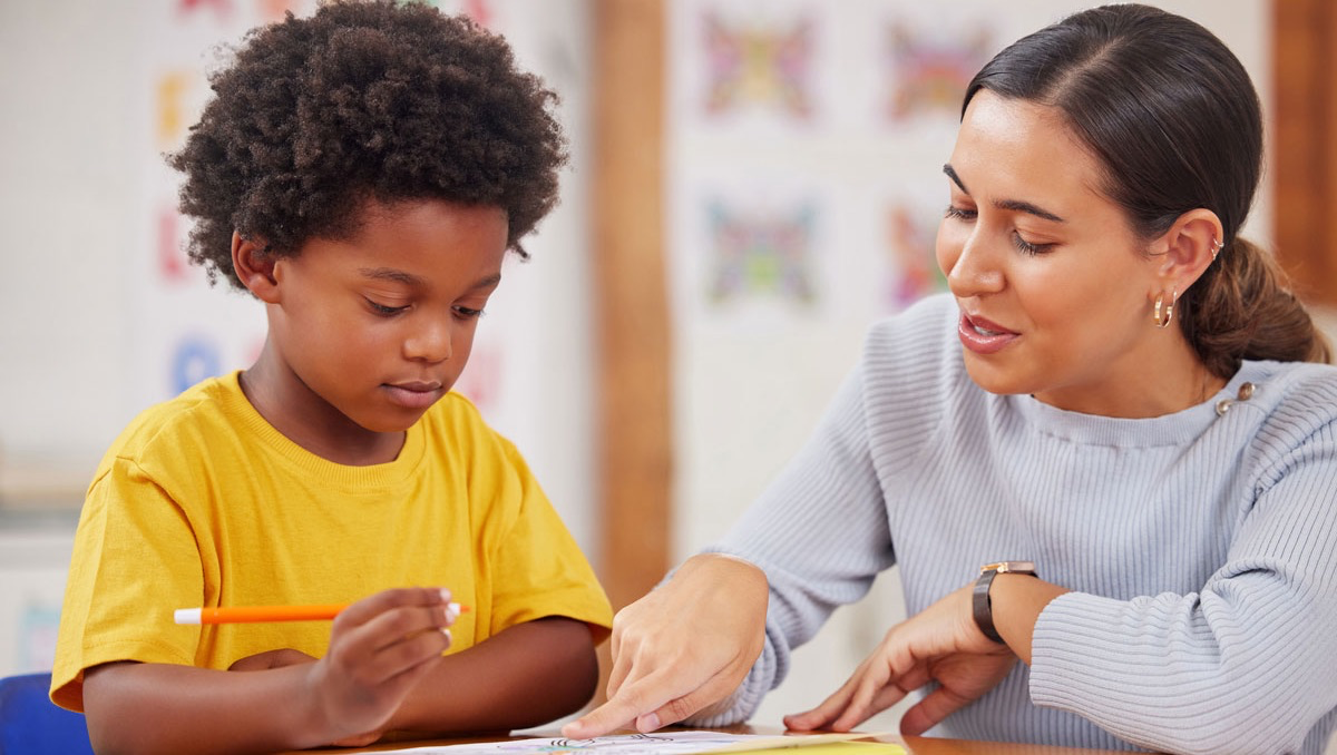 Tutor teaching child at home